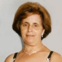 Woman smiling in formal attire.