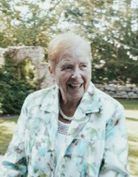Elderly woman smiling in garden setting