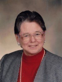 Smiling person in glasses and checkered outfit