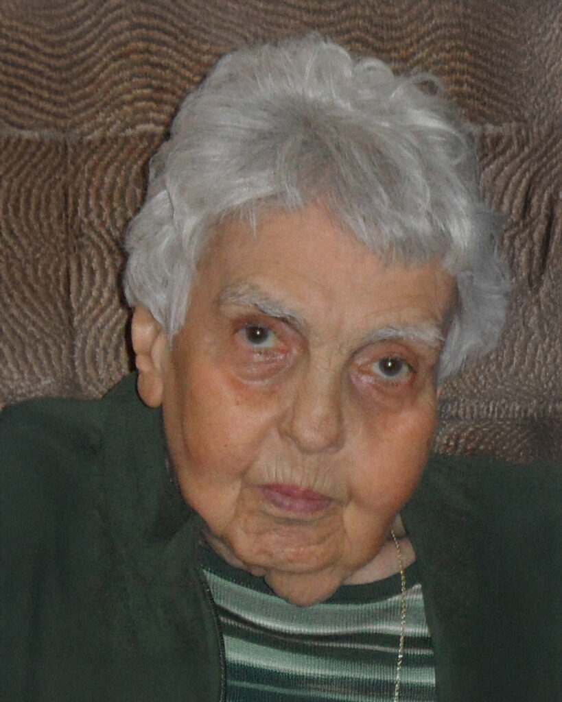 Elderly person with gray hair and striped shirt.