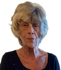 Elderly woman with gray hair and black shirt.