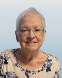 Smiling elderly woman with short hair and glasses