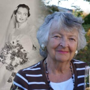 Older woman with wedding photo backdrop.