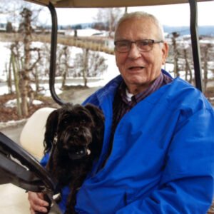 Man with dog on a snowy golf course