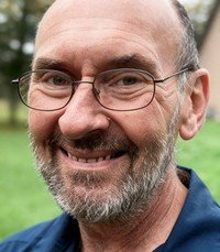 Smiling man outdoors in a garden setting