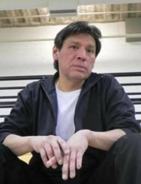 Person sitting on bleachers, looking thoughtful