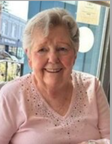 Elderly woman smiling in a cafe