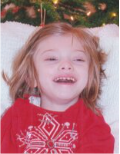 ANDREWS, Ella Sharon Andrews Child smiling in festive red sweater.