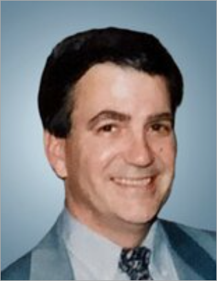 Smiling man in suit portrait, blue background.
