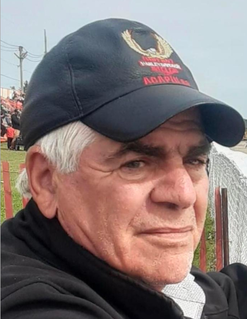 Man wearing a cap outdoors at an event
