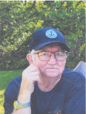 Elderly man with cap and glasses in garden