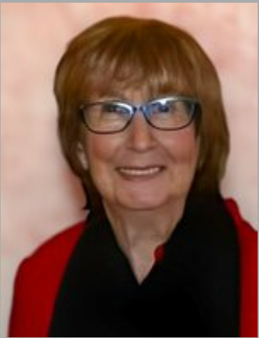 Woman smiling in glasses with red and black attire.