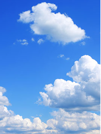 Blue sky with fluffy white clouds.