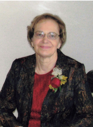WRIGHT, Marie Wright Smiling woman in floral dress with corsage.