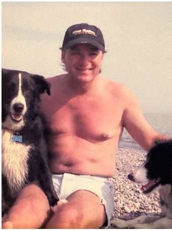 Man with two dogs on a beach