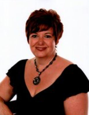 Smiling person wearing black top and necklace