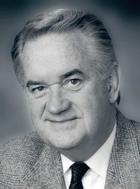 Portrait of an older man in a suit.