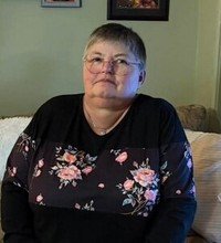 Person sitting on sofa with floral shirt
