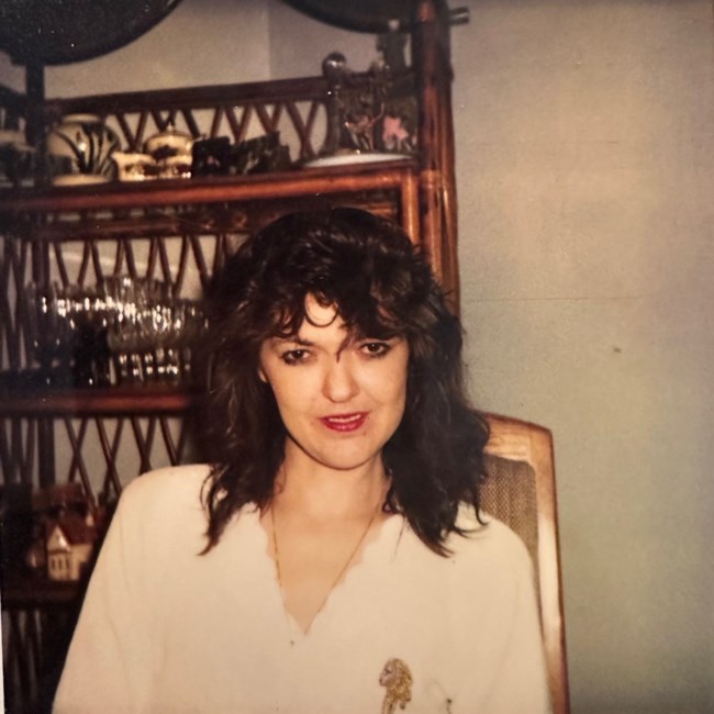 Woman sitting by a wooden shelf, vintage photo.