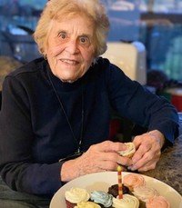 Smiling woman with cupcakes on a table