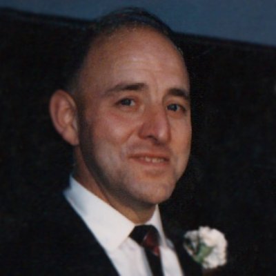 Portrait of man in suit with flower boutonniere.