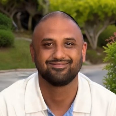 Smiling person outdoors with green background