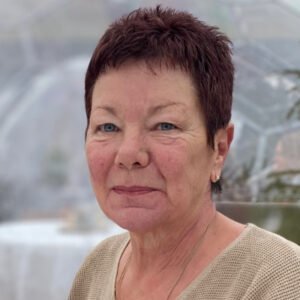 Portrait of a woman with short hair indoors.