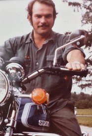 Man sitting on a motorcycle outdoors