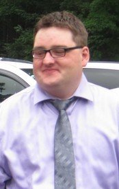 Person in formal attire standing outside.