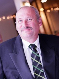 Smiling man in formal attire indoors