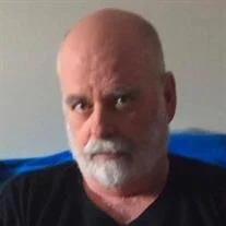 Bald man with beard looking at camera.