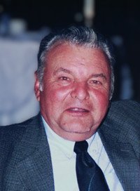 Smiling elderly man in a suit and tie.