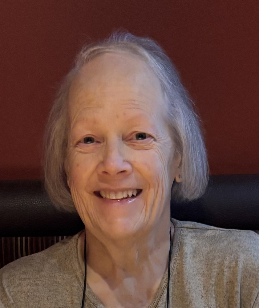 ROSS, Susan Elizabeth Ross Smiling elderly woman with gray hair indoors.