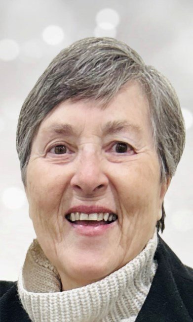 Smiling older woman with short gray hair.