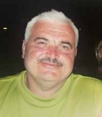 Smiling person in a green shirt