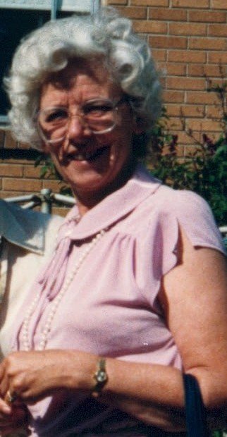 Smiling woman in pink blouse outdoors