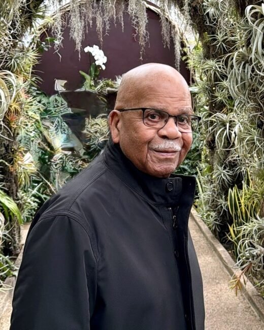 Man standing in lush garden walkway
