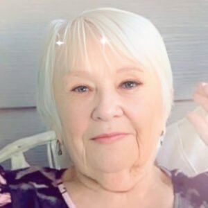 Smiling elderly woman with white hair.