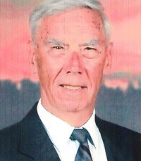 Elderly man in suit with sunset background.