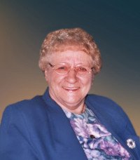 Smiling person in glasses and blue outfit
