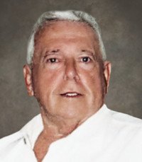 Elderly man in a white shirt smiling