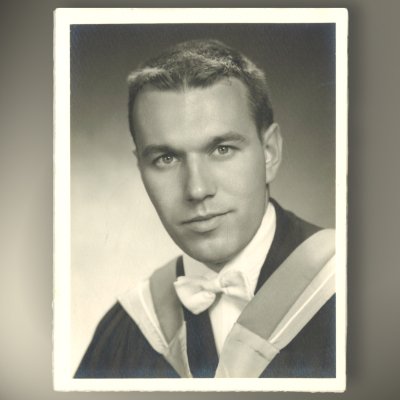 Black and white graduation portrait of a man.