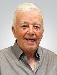 Smiling elderly man with short white hair.