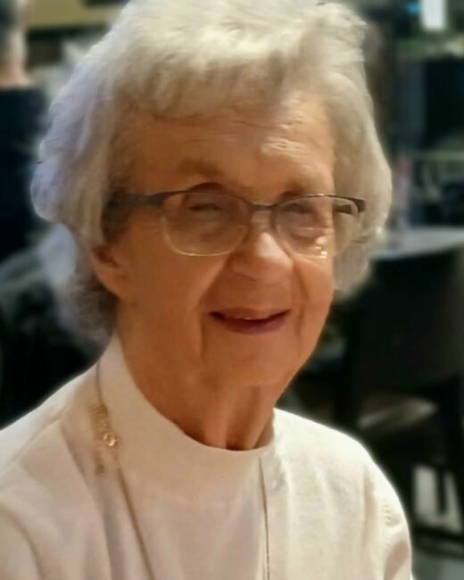 Elderly woman smiling inside a restaurant