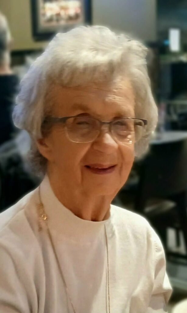 Elderly woman smiling inside a restaurant