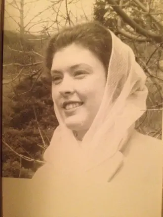 Smiling woman with headscarf, vintage photograph.