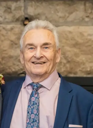 Smiling man in suit and floral tie