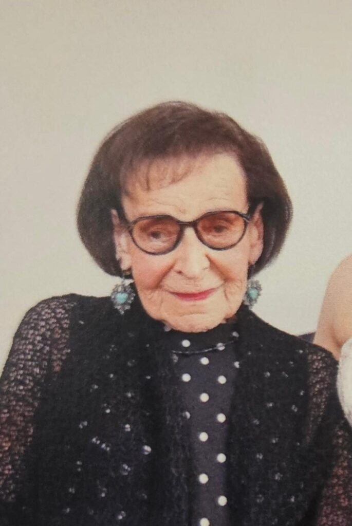 Elderly woman wearing glasses, polka dot outfit