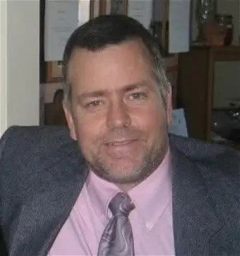 Man in suit smiling at camera