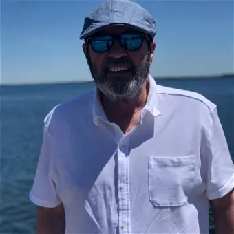 Man in white shirt by the water